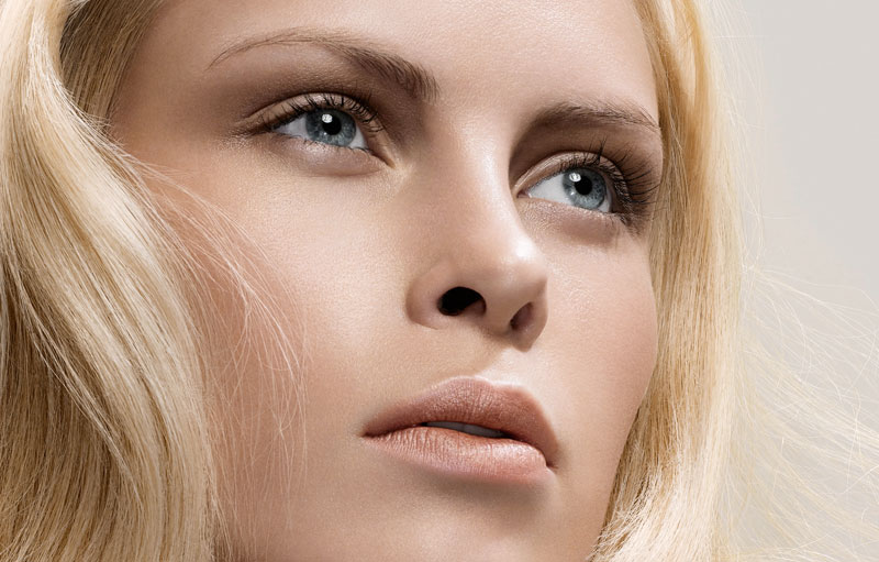 Closeup on a young woman with long and full lashes